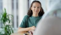 A young woman talking to her doctor